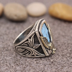 Men's vintage eagle ring with blue turquoise stone and gold eagle relief on silver band