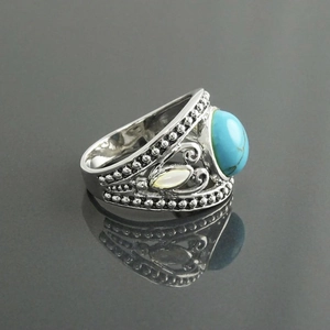 Dettaglio macro dell'anello bohémien con turchese, incisioni d'argento e riflesso