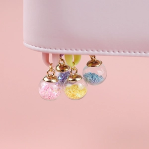 Star-filled glass ball charms in pink, yellow, blue, and purple for DIY jewelry making