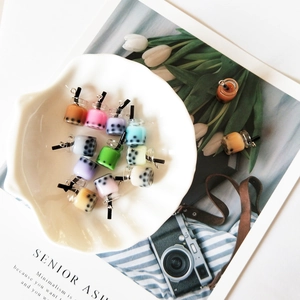 Colorful mini bubble tea resin pendants in a decorative bowl for DIY jewelry and crafts