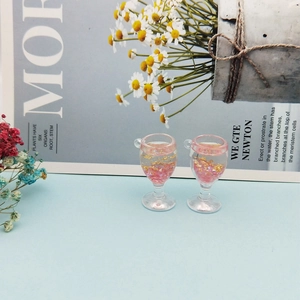 Detailed view of mini acrylic wine glass charms with pink glitter for DIY jewelry making