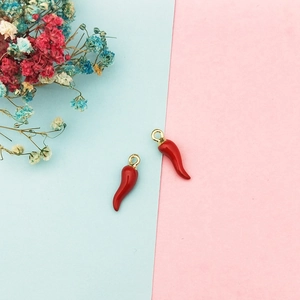 Detailed macro view of two red chili alloy charms with gold rings for DIY jewelry making