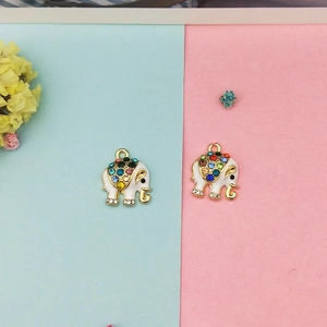 Detailed view of gold elephant charms with white enamel and colorful rhinestones for DIY