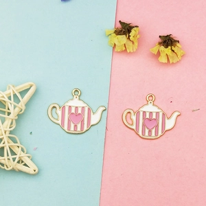 Detail of pink and white striped teapot charms with heart detail for DIY jewelry making