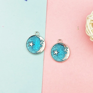 Detailed view of blue celestial moon and star alloy charms for DIY jewelry making