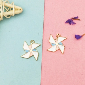 Macro view of colorful enamel windmill pendants with gold plating for DIY jewelry making