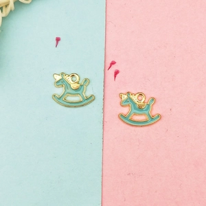 Macro shot of a mint green rocking horse unicorn pendant with golden metal frame for DIY jewelry