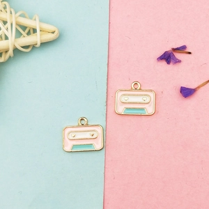 Macro shot of retro cassette alloy pendants in pink and blue for DIY jewelry making