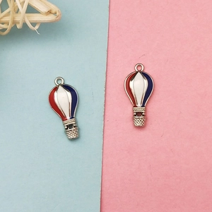 Detailed close-up of hot air balloon enamel charms with red white and blue patterns