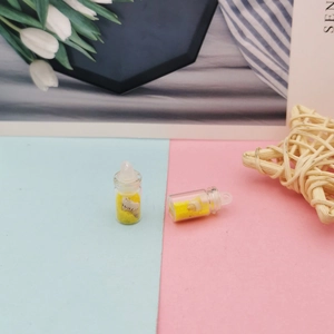 Gros plan de mini bouteilles de vœux avec sable jaune et coquillages pour loisirs créatifs