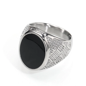 Close-up of a silver titanium ring with black enamel oval stone and side grid details