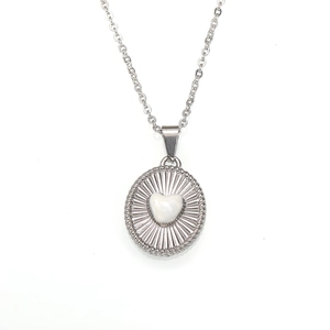 Detail of vintage 18K gold plated steel necklace with 3D heart and radial textured pendant
