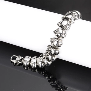 Macro detail of gothic skull chain links and cross clasp in polished steel