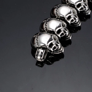 Macro shot of silver stainless steel skull pendants with detailed punk engraving