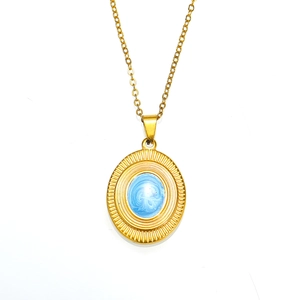 Macro view of gold sunburst pendant with blue marble inlay and fine link chain