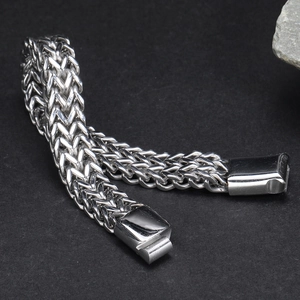 Detailed macro view of a men's double-row stainless steel bracelet with a polished magnetic clasp
