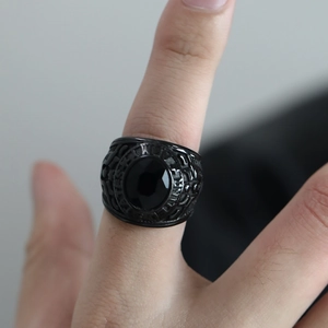 Detailed close-up of vintage black titanium United States Army ring with faceted gemstone