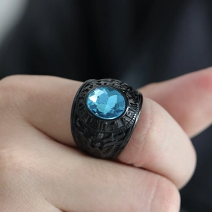 Macro detail of US Army ring with blue gemstone and eagle engraving on black metal