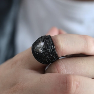 Close-up of U.S. Army embossed lettering and grey gemstone on black steel ring