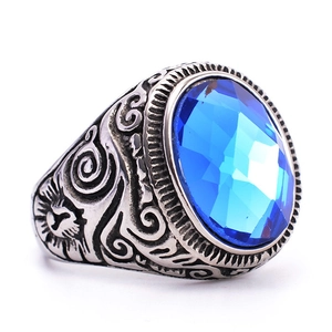 Vintage titanium steel ring for men featuring a large oval blue sapphire and sun engraving