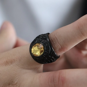 Detail of vintage United States Army ring with black matte finish and yellow gemstone