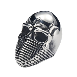 Macro shot of punk biker skull ring featuring US flag mask detail and gothic metal finish