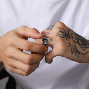 Macro shot of men's vintage bicycle chain ring with industrial hollowed detail on finger