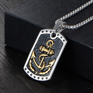 Detailed macro view of retro stainless steel military tag pendant with golden anchor icon