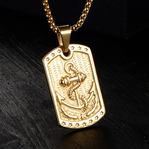 Macro shot of gold stainless steel military tag pendant with anchor and star relief