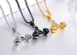 Close-up of dumbbell pendants in silver, black and gold finishes on box chains