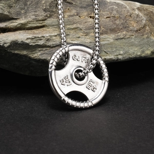 Close-up of titanium steel barbell weight plate pendant with Go Fit 45 LBS engraving