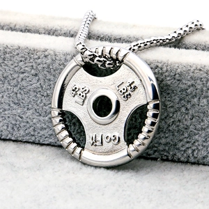 Macro detail of barbell pendant with Go Fit engraving and 45 LBS weight marking