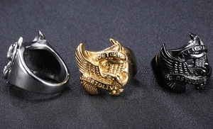 Detailed close-up of men's hawk rings in silver gold and black with engraved motorcycle mottos