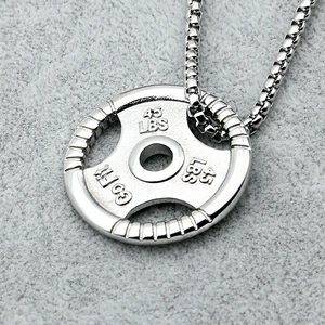 Macro shot of silver dumbbell pendant with 45 LBS engraving and steel box chain