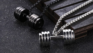 Close-up of black and silver dumbbell pendants on heavy steel chains for fitness lovers
