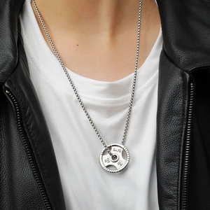 Close-up of silver fitness necklace with Go Fit 45 LBS weight plate pendant on box chain