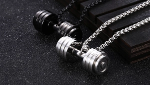 Macro shot of stainless steel dumbbell pendants in matte black and polished silver finish