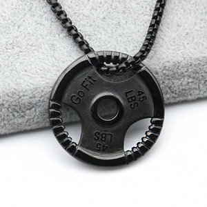 Detailed macro view of black barbell plate pendant with Go Fit and 45 LBS engravings