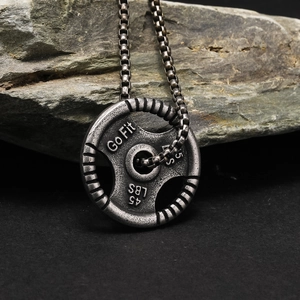 Rugged fitness necklace with Go Fit 45 LBS weight plate pendant on black industrial stone