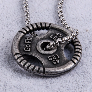 Detailed close-up of a vintage steel dumbbell pendant with GoFit 45LBS engraving