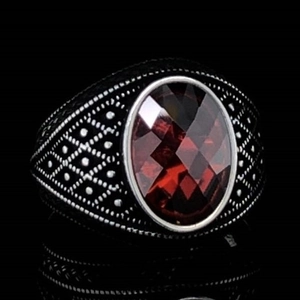 Retro men's silver alloy ring featuring an oval red faceted gemstone and carved textures