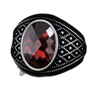 Vintage black alloy men's ring with a faceted oval red gemstone and textured engravings