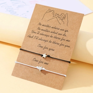 Close-up of black and white star charm cord bracelets on a Pinky Promise gift card
