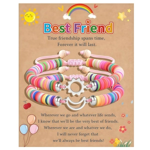 Detail of colorful heishi bead friendship bracelets with sun and moon charms on gift card