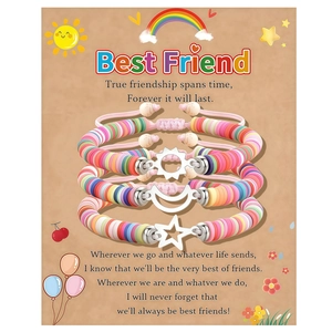 Close-up of three friendship bracelets with sun moon and star charms on gift card