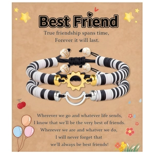 Detail of adjustable woven friendship bracelets with sun and moon pendants on gift card