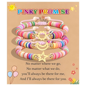 Detailed view of colorful clay heishi bead bracelets with sun, moon, and star charms