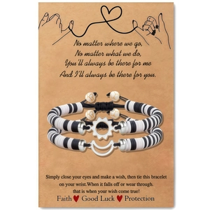Detail of sun and moon couple bracelets with black and white beads on display card