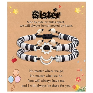 Two-piece sun and moon woven friendship bracelets with adjustable clay beads on display card