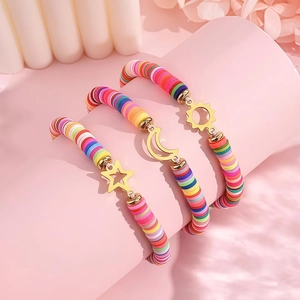 Close-up of bohemian sun, moon, and star charms on colorful beaded friendship bracelets